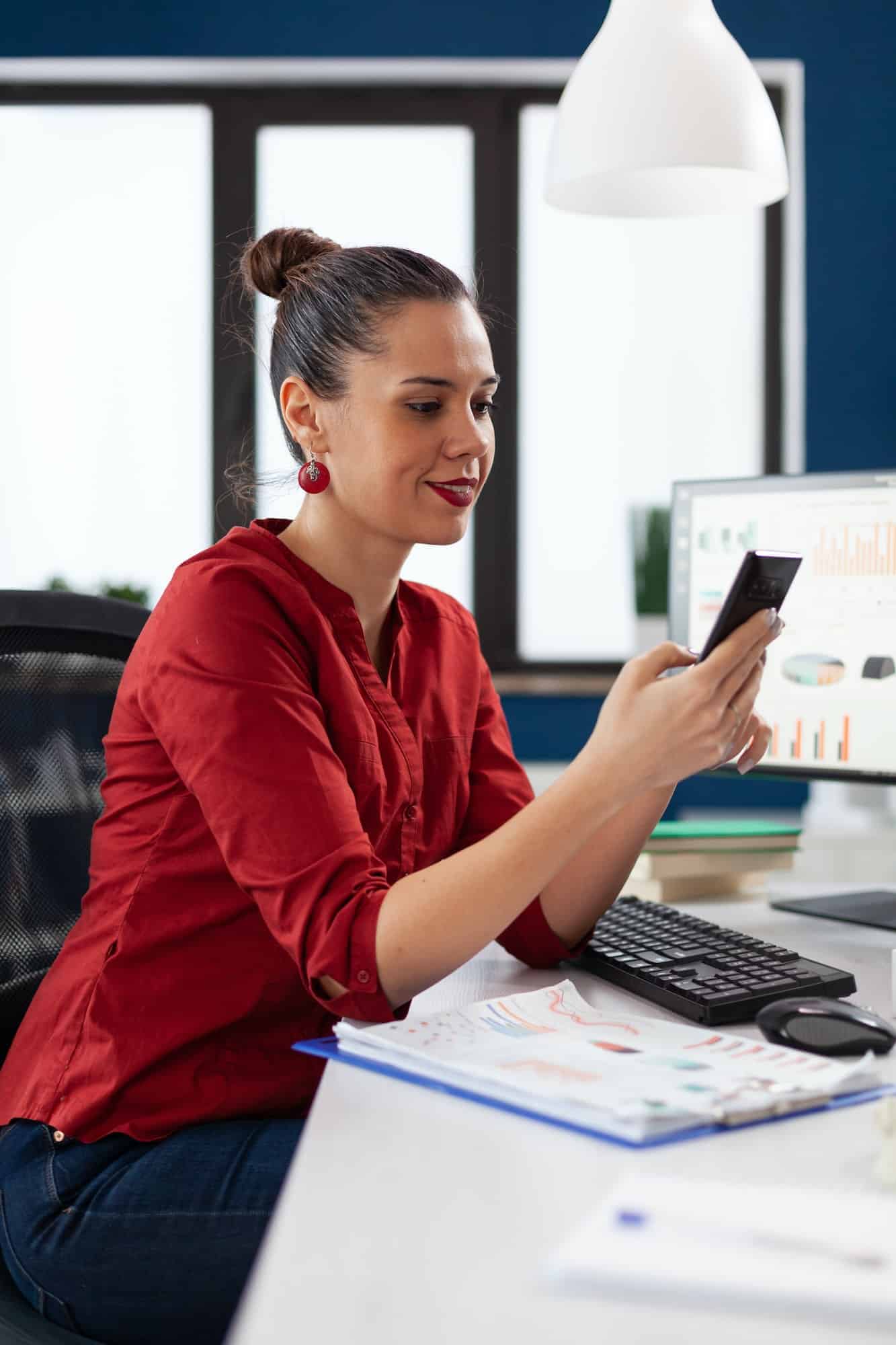 Manager using smartphone in startup business office