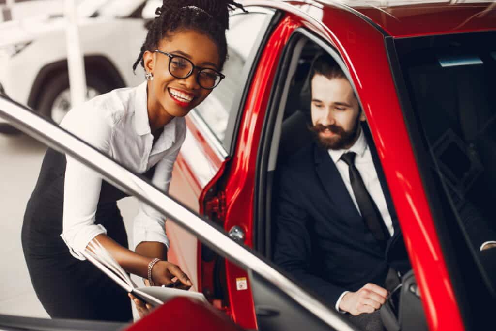 Stylish black woman in a car salon